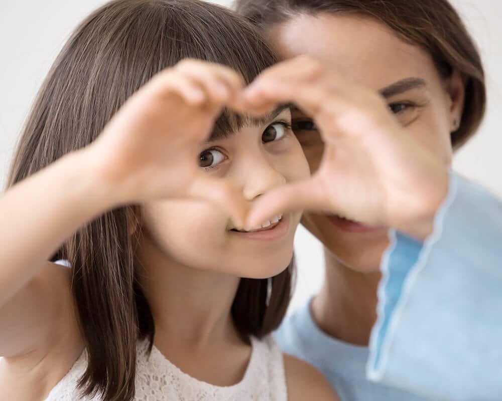 Child Making a Heart With Her Hands