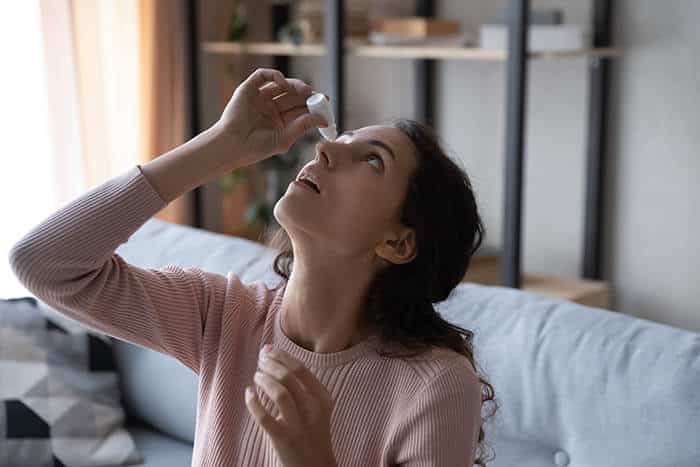 Woman Putting in Eye Drops